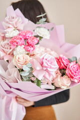 Young woman making fashion modern bouquet in korean style of different flowers. colorful color mix flower. Floral shop concept. Flowers delivery