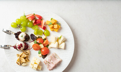 Various cheeses, fruits and raw ham	