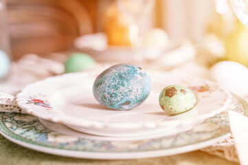 happy easter holiday in springtime season. painted green emerald colored eggs in bowl and plate on table. festive home decor. traditional food. sophisticated country rustic tablescape style. flare