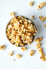 Caramel popcorn in a bowl, on a white background