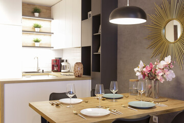 Dining table in the kitchen with plates, utensils and big vase with flowers bouquet
