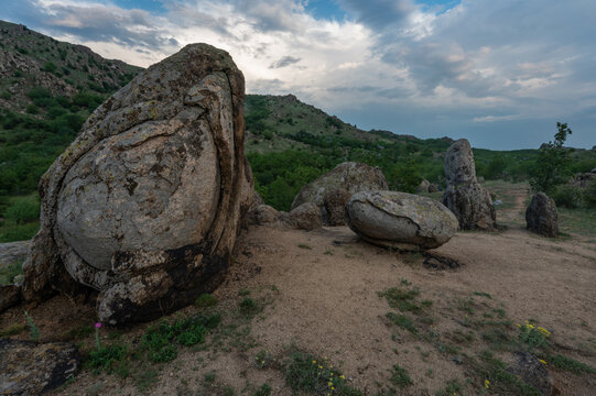 Sunrise in romanian national park mountains munti macin above danube rocks and stones and green meadows