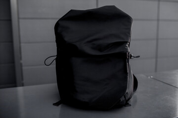 Close-up of the bagpack against the gre background of grey wall