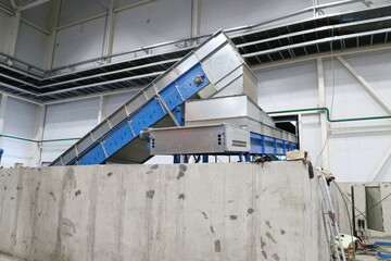 conveyors in the workshop of a waste sorting plant
