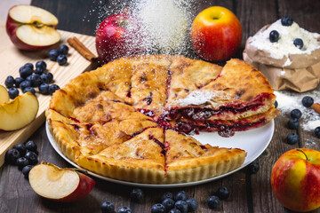 cherry pie on the table with powdered sugar