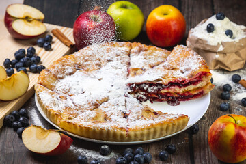 cherry pie on the table with powdered sugar