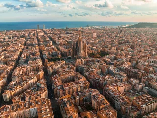 Fotobehang Barcelona Aerial view of Barcelona City Skyline and Sagrada Familia Cathedral at sunset. Eixample residential famous urban grid. Cityscape with typical urban octagon blocks  © Aerial Film Studio