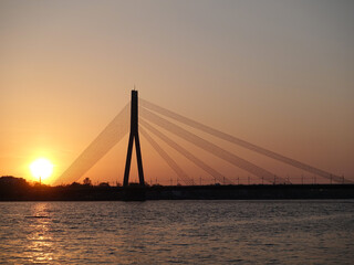 Fototapeta na wymiar The silhouette of Vansu Bridge in Riga at sunset