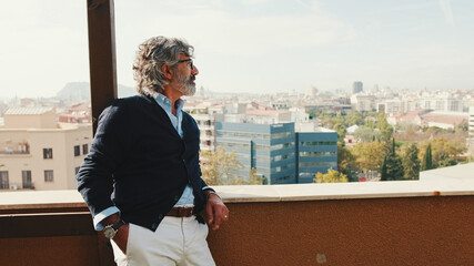 Senier enjoys the view standing on the balcony