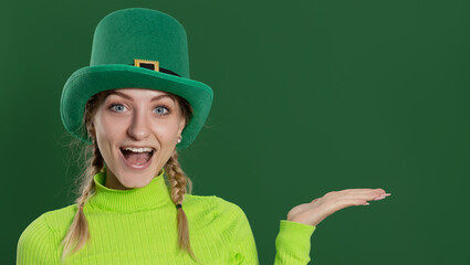 St. Patrick's Day leprechaun model girl in green hat, funny clover shaped sunglasses, isolated on...