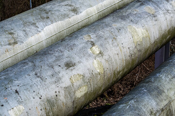 closeup of large metal district heating pipes side by side
