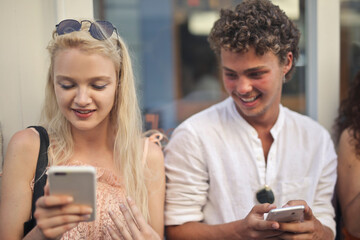 young couple with smartphones in hand