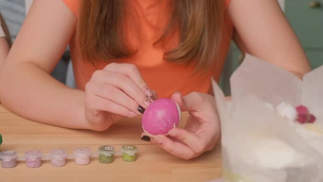 Mom and daughter are getting ready to celebrate Easter and paint eggs. Kiss your daughter.