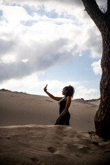 african girl taking selfie in the desert