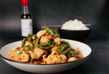 Close up, Tasty Stir-fried pork and red hot curry paste with or long bean and Ingredients are oyster sauce, fish sauce, sugar, kaffir lime leaves in the dish Eat with cooked rice. Thai food