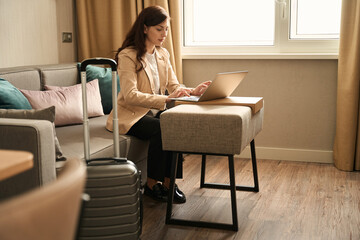 Traveling woman is checking into a hotel