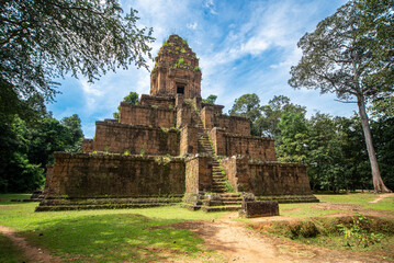 Siem Reap, complex of Angkor Wat, Angkor Thom, view of the archeological site with blue sky in the middle of the tropical forest. Sense of exploration in the ruins of an ancient civilization.