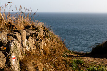 Sign for Coastal Walk GR223 from Flamanville to Plage de Sciotot on a sunny afternoon, Normandy, France
