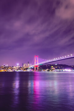 Vertical image of 15 July Martyrs Bridge (15 Temmuz Sehitler Koprusu) Violet, purple cloudy sky and sea in Istanbul, Turkey. Istanbul Bosphorus Bridge, Panorama, long exposure, Vertical İmage. © YALÇIN KAHYA