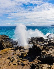 Tourist Behind The Spray of The Nakalele Blow Hole on Nakalele Point, Maui, Hawaii, USA