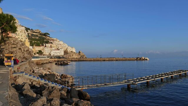 Amalfi, Italy. View of Amalfi from the Lungomare dei Cavalieri on a winter day at the end of December. In the foreground, a dock in the marina for pleasure boats. 2022-12-28.