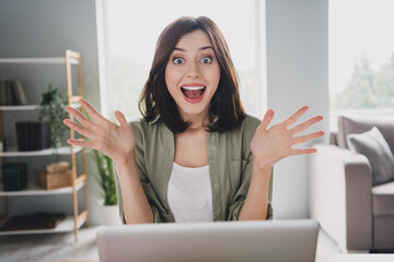 Photo of astonished overjoyed girl pen mouth raise arms cant believe use netbook workstation indoors