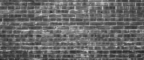 Fototapeta na wymiar Grayscale backdrop with old realistic black brick wall. Minimal fragment of brickwall close-up. Minimalist monochrome background with wall of gray bricks in different shades. Simple wall texture.