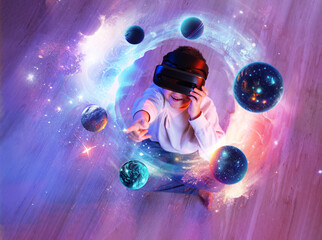 Child boy wearing virtual reality headset and looking at digital space system with planets or Universes. Space exploration with augmented reality glasses. He sits on floor. View above