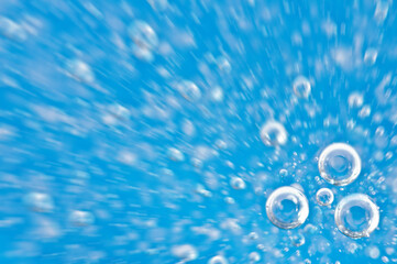 Water close up. Movement of water with oxygen bubbles. Blue beautiful underwater background