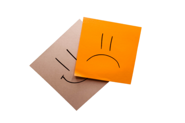 Orange and white memo with drawn a sad and happy face with black background. Being negative rather than live positive. Smile and pout. Representation of sadness. Without background; transparent