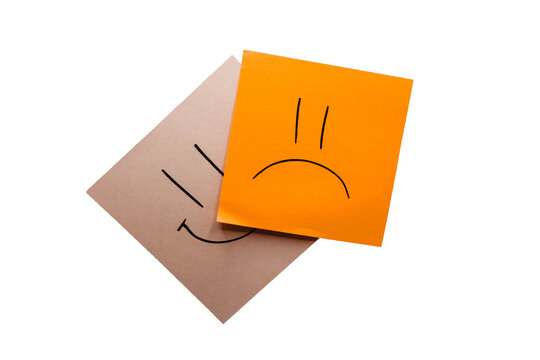 Orange and white memo with drawn a sad and happy face with black background. Being negative rather than live positive. Smile and pout. Representation of sadness. Without background; transparent