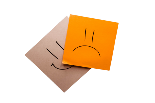 Orange and white memo with drawn a sad and happy face with black background. Being negative rather than live positive. Smile and pout. Representation of sadness. Without background; transparent