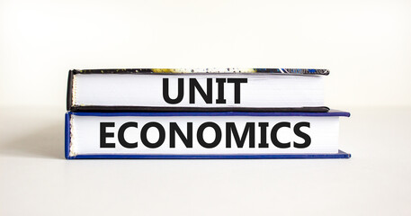 Unit economics symbol. Concept words Unit economics on books. Beautiful white table white background. Business and unit economics concept. Copy space.