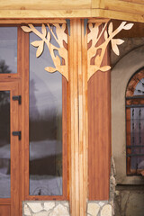 Decorating the facade of the building with a carved panel imitating wood.