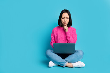 Naklejka premium Full length photo of shiny thoughtful woman dressed pink sweater working modern gadget isolated blue color background