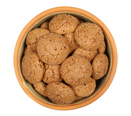 Sweet cookies with apricots in clay pot isolated on white, texture, top view