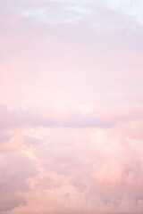Sky with soft and fluffy pastel pink and blue colored clouds. Sunset background. Nature. sunrise. Instagram toned style. Vertical
