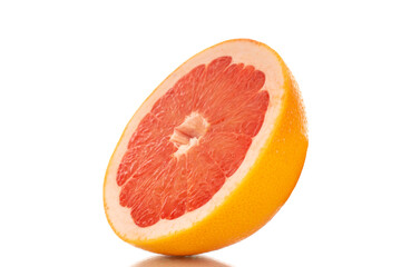 One half of a ripe grapefruit, macro, isolated on white background.