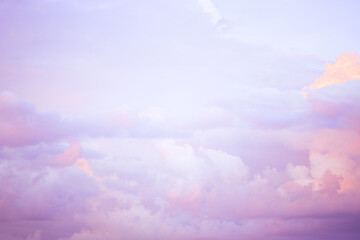 Obraz premium Sky with soft and fluffy pastel lilac pink and blue colored clouds. Sunset background. Nature. sunrise. Instagram toned style