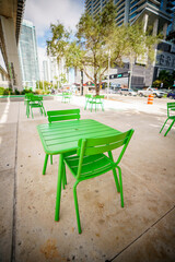 Fototapeta na wymiar Public green tables and chairs at the Brickell Underline Miami