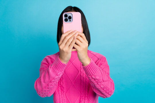 Photo of girl hands hold telephone make selfie record video cover face isolated on blue color background
