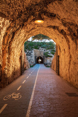 Tunnels of the Cantal, between Rincon de la Victoria and Cala del Moral, Malaga, promenade that runs through tunnels and cliffs facing the Mediterranean, at dawn.