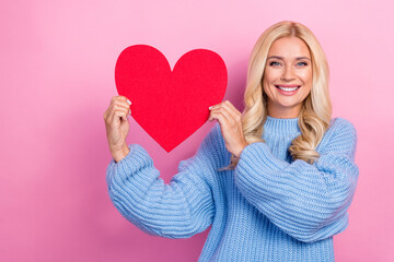 Photo of adorable stunning glad lady hand hold red paper card promote clinic cardiology empty space isolated on pink color background © deagreez