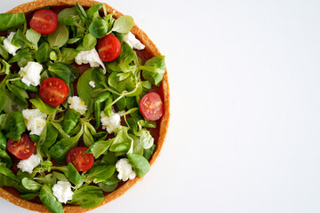 Cake of vegetables lying on the white background. Healthy cooking concept