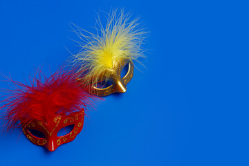 Multicolored carnival mask on blue background. Purim.