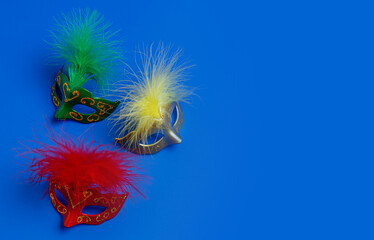 Multicolored carnival mask on blue background. Purim.