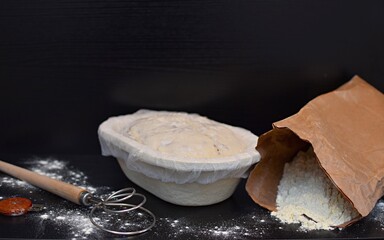 yeast dough and paper bag with flour
