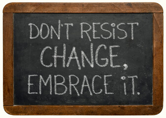 Fototapeta premium do not resist change, embrace it - motivational phrase on a vintage slate blackboard