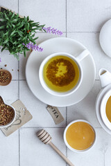 Buckwheat tea with honey on a white background with flowers.