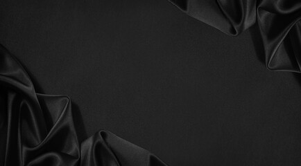 Black silk satin surface. Dark elegant background for design, text or product. Copy space. Table...